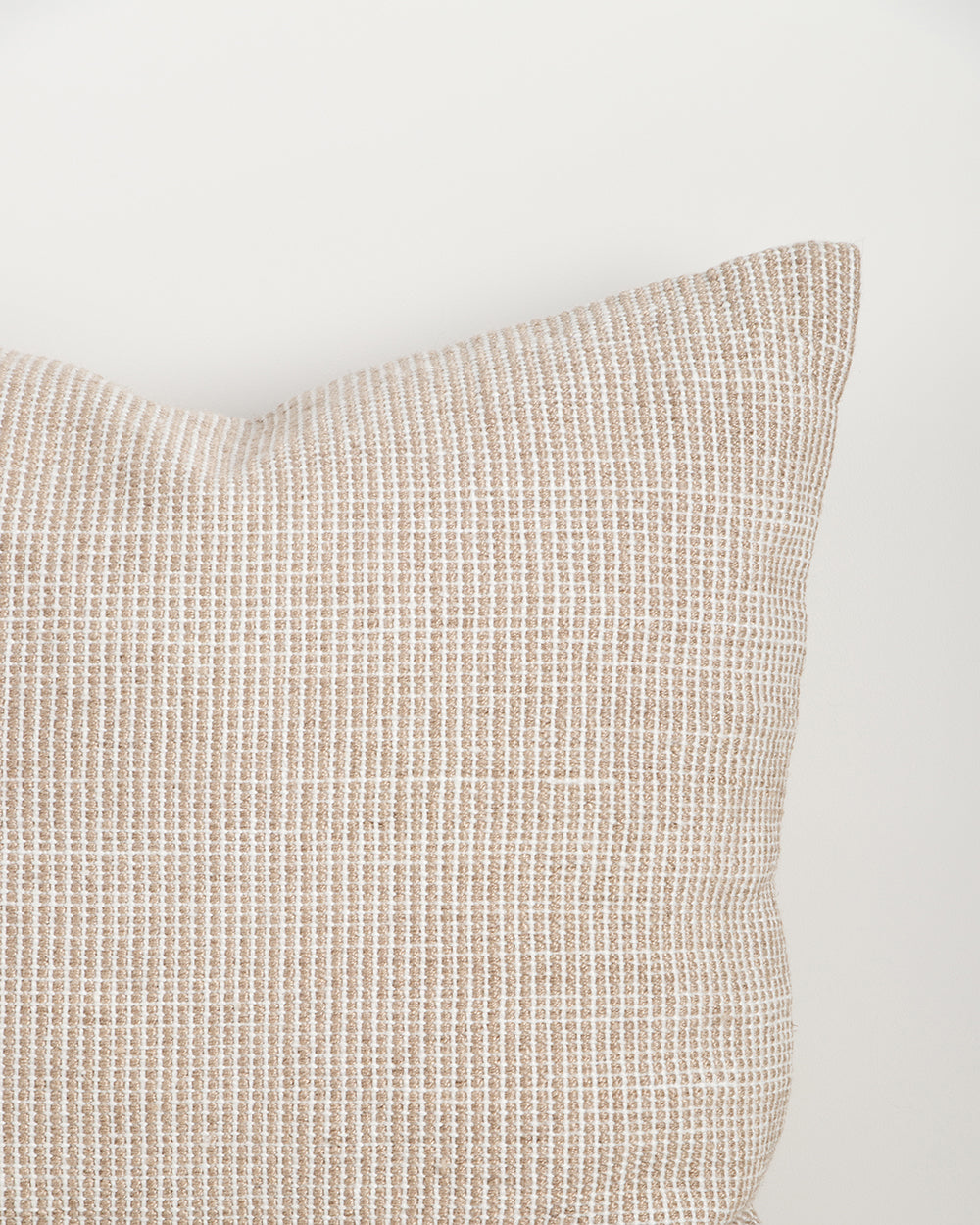 Close-up of the corner and weave texture on the Baya Dune outdoor cushion in Almond