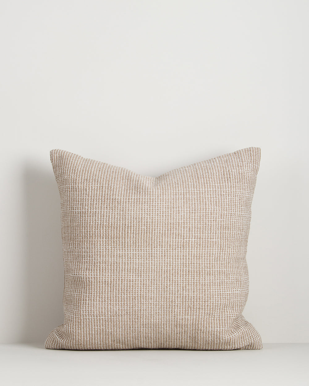 Baya Dune outdoor cushion in Almond, front view on a plain background, showing the handwoven bi-colour texture