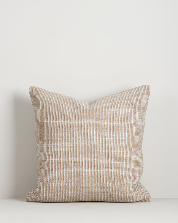 Baya Dune outdoor cushion in Almond, front view on a plain background, showing the handwoven bi-colour texture