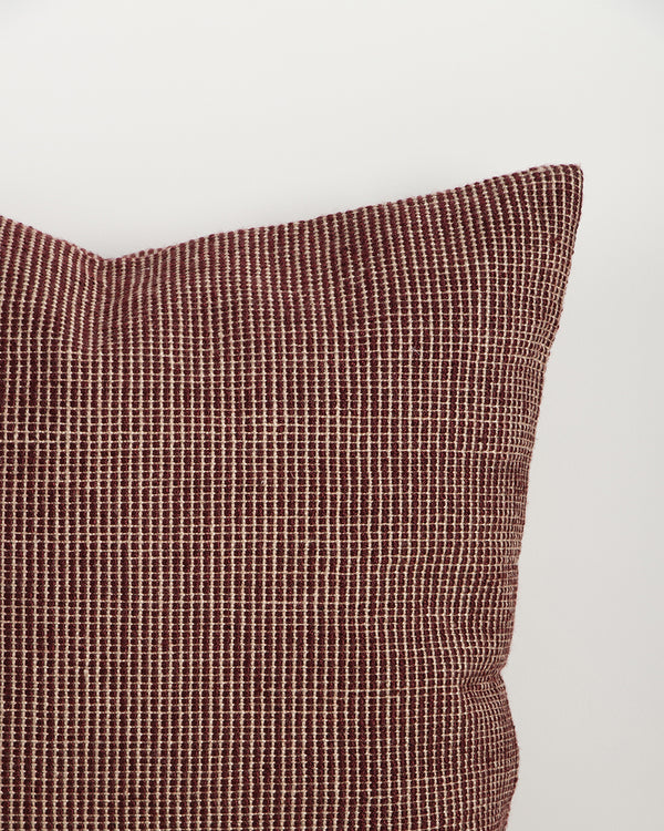 Close-up of the corner and weave texture on the Baya Dune outdoor cushion in Claret