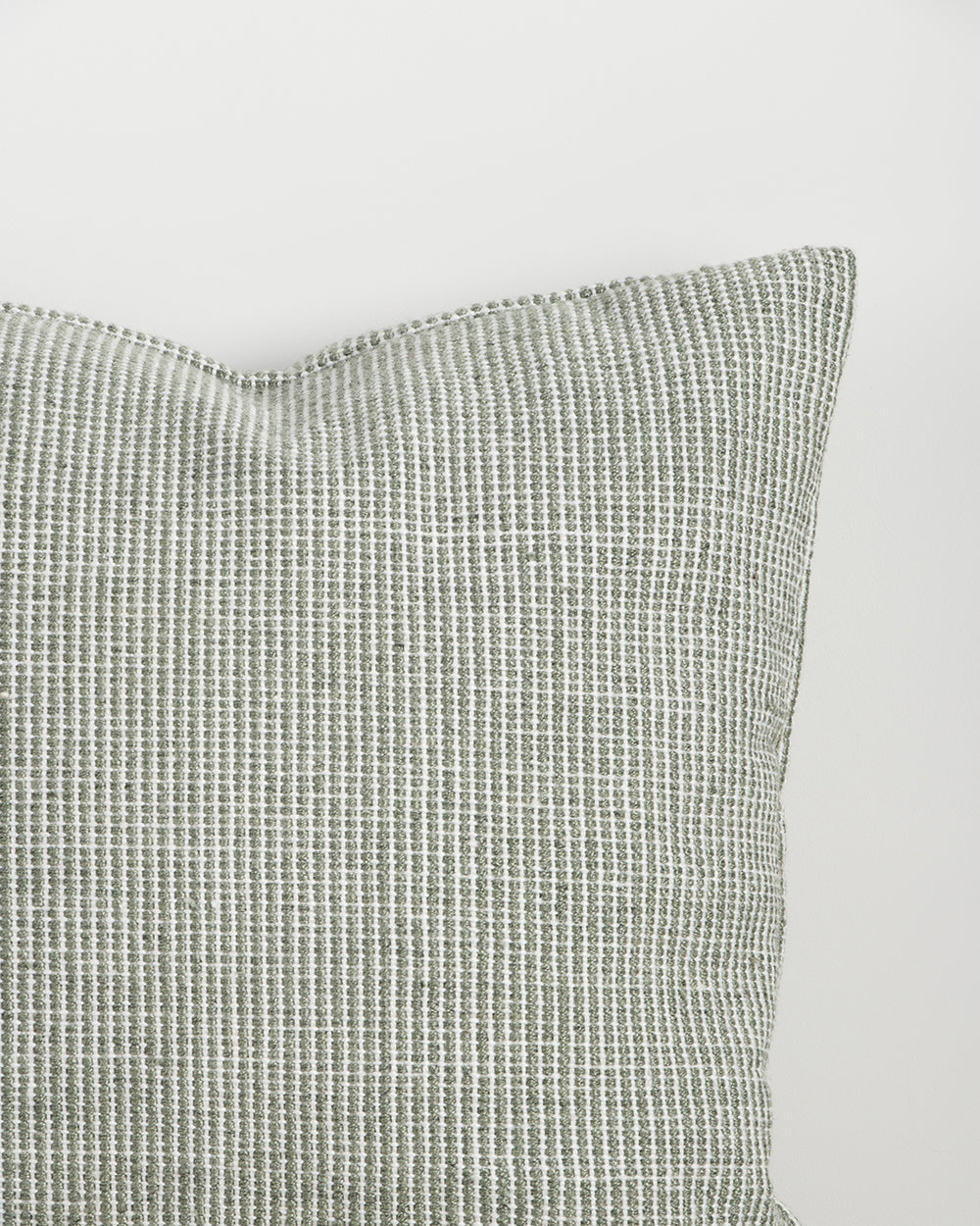 Close-up of the corner and weave texture on the Baya Dune outdoor cushion in Eucalyptus
