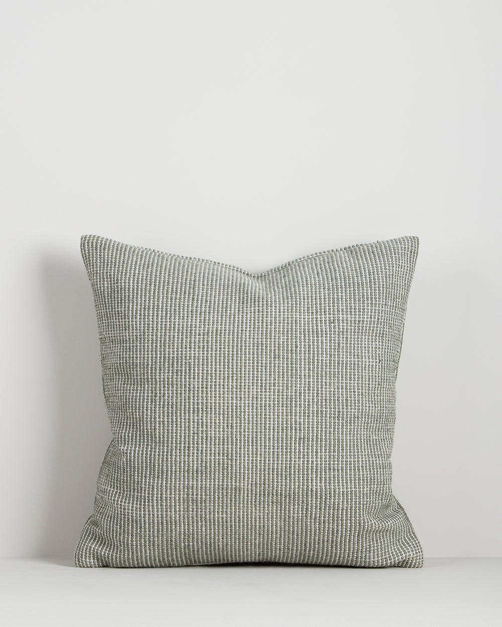 Baya Dune outdoor cushion in Eucalyptus, front view on a plain background, showing the handwoven bi-colour texture