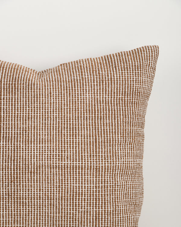 Close-up of the Baya Dune outdoor cushion in Tobacco, showing the colour-blocked stripe weave