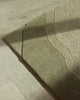 Baya Edgewater NZ wool floor rug in Pistachio, rectangle, close view of a corner in raking light showing the fine dark wave lines.