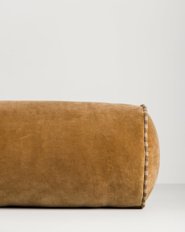 Baya Elliot cotton velvet bolster cushion in Butterscotch, close view of the velvet texture and striped piped end