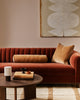 Baya Elliot cotton velvet bolster cushion in Butterscotch, styled on a rust velvet sofa with the matching Edward box cushion
