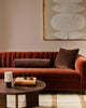 Baya Elliot cotton velvet bolster cushion in Chocolate, styled on a rust velvet sofa with a matching square cushion