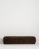 Baya Elliot cotton velvet bolster cushion in Chocolate on a plain background
