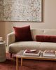 Baya Elliot cotton velvet bolster cushion in Oxblood, close view on a cream boucle sofa with a matching square cushion