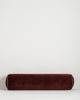 Baya Elliot cotton velvet bolster cushion in Oxblood on a plain background