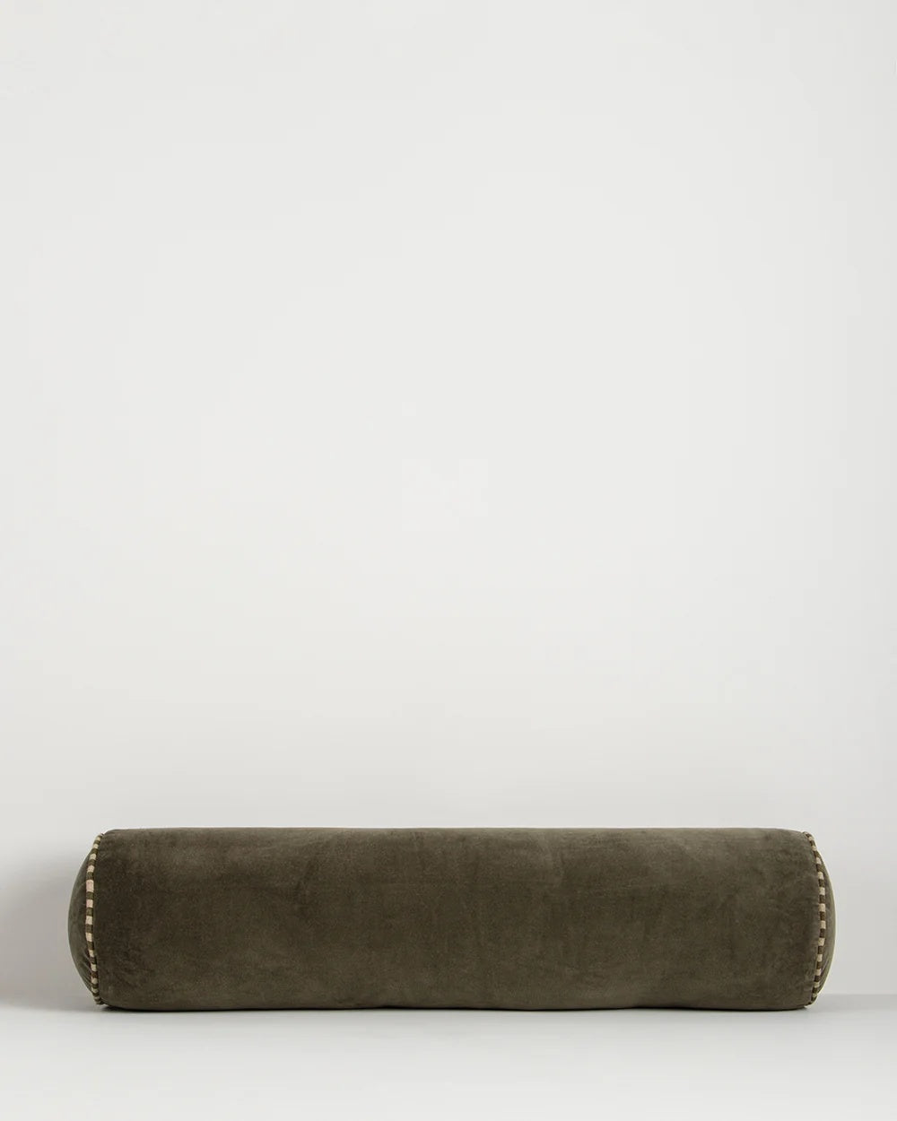 Baya Elliot cotton velvet bolster cushion in Thyme on a plain background