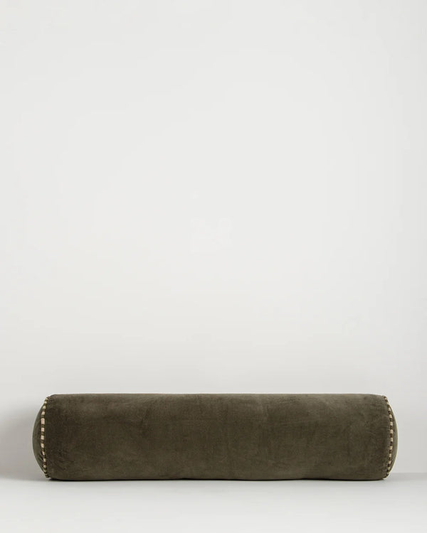Baya Elliot cotton velvet bolster cushion in Thyme on a plain background