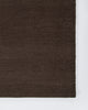 Baya Fairmont NZ Wool Floor Rug in Bracken, close view under a dining table set with a vase of flowers and a napkin