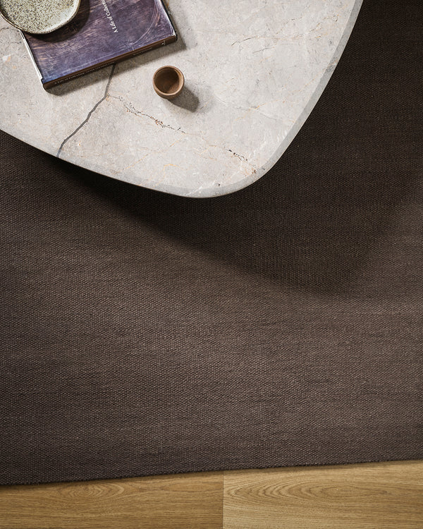Baya Fairmont NZ Wool Floor Rug in Bracken, overhead view beside a round marble side table with a book