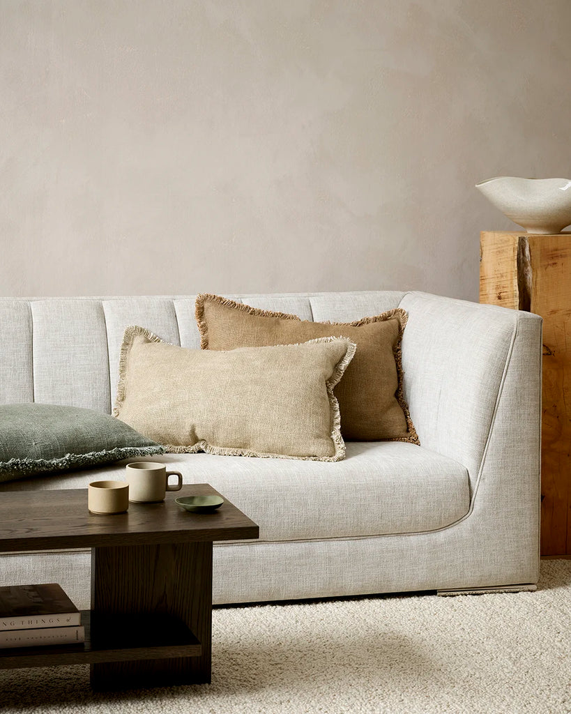 Baya 'Dover' cushions with fringe detail, decorating a couch in a stylish living room