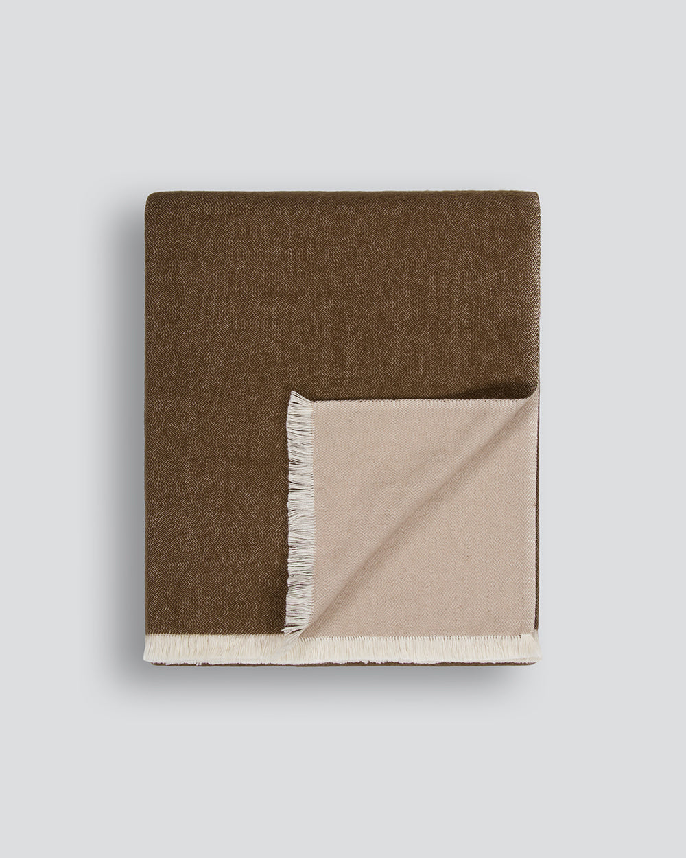 Baya Langford throw in coffee, a warm mid-brown, folded flat to show the fringed edge and beige reverse.