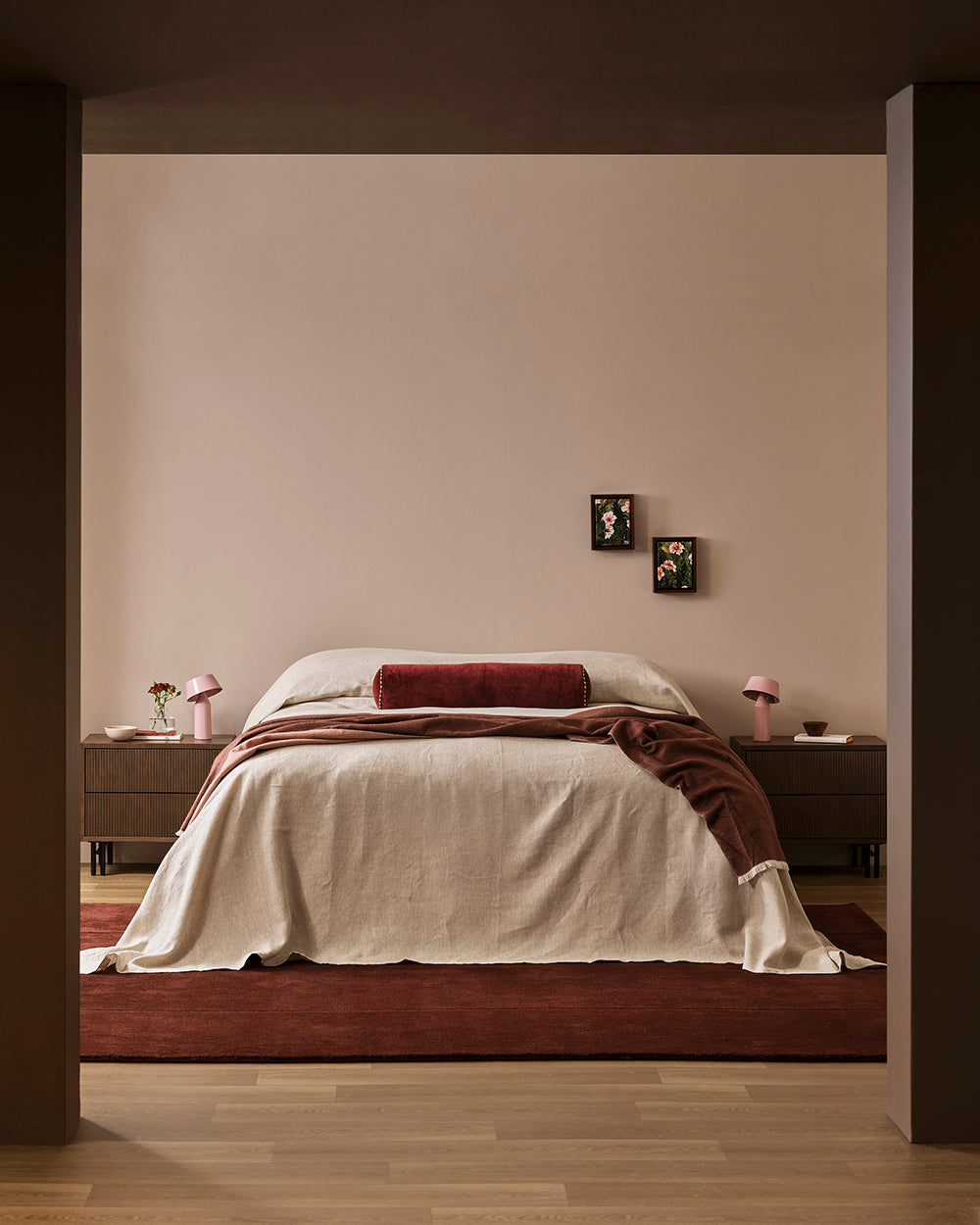 Baya Langford throw in raisin draped over a bed, seen through a wide archway.