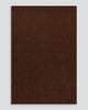 Full-length view of the Baya Linden Floor Rug in Brick, a handwoven flatweave rug in an earthy, faded red-brown wool.