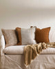 A selection of baya linen cushions in rust tones