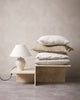 Pile of neutral cushions in creams, beige and pale brwon, by Baya nz