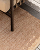 Baya Ormond outdoor rug in Biscotti, styled on a timber deck beneath an outdoor chair.