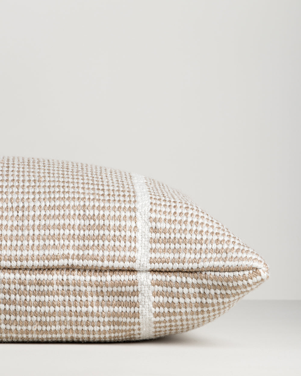 Close-up of the end seam and weave on the Baya Shore outdoor lumbar cushion in Almond