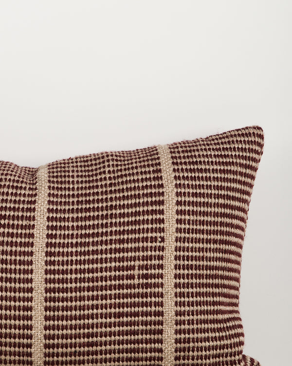 Close-up of the corner and weave texture on the Baya Shore outdoor lumbar cushion in Claret