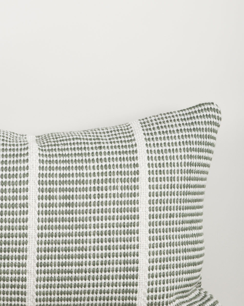 Close-up of the corner and weave texture on the Baya Shore outdoor lumbar cushion in Eucalyptus
