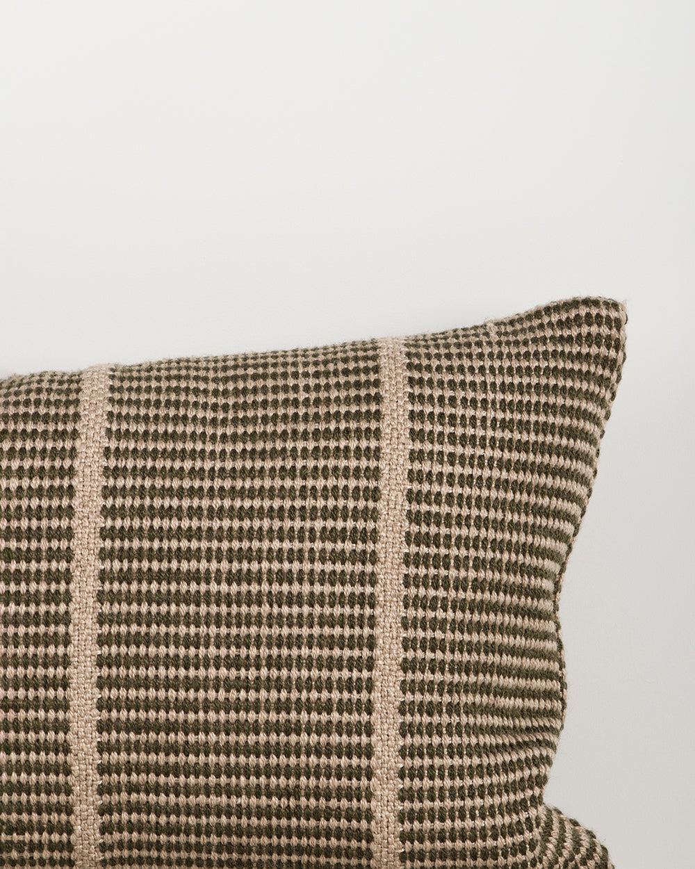 Close-up of the corner and weave texture on the Baya Shore outdoor lumbar cushion in Mangrove