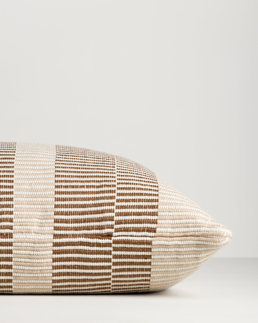 Baya Solar Outdoor Lumbar Cushion in Chocolate, close view of the end gusset and stripe weave.
