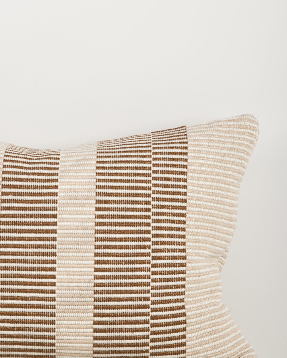 Baya Solar Outdoor Lumbar Cushion in Chocolate, close view of the woven stripe texture in brown and cream.