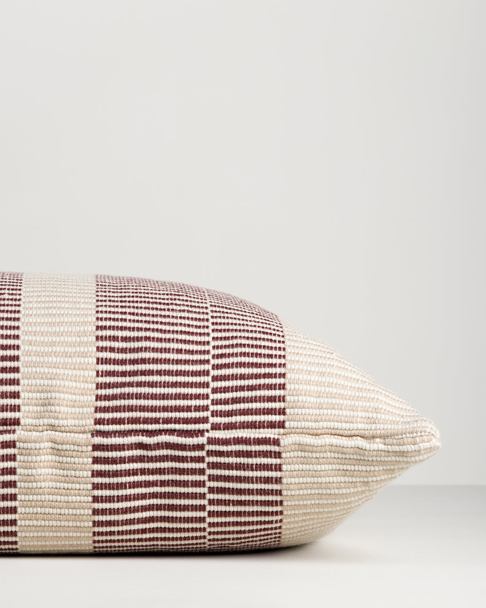 Baya Solar Outdoor Lumbar Cushion in Claret, close view of the end gusset and linework weave.