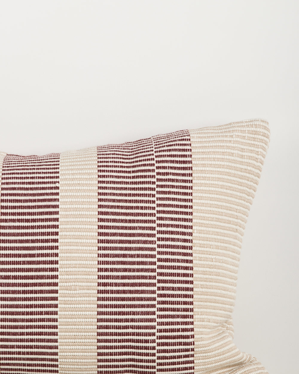 Baya Solar Outdoor Lumbar Cushion in Claret, close view of the woven linework texture.
