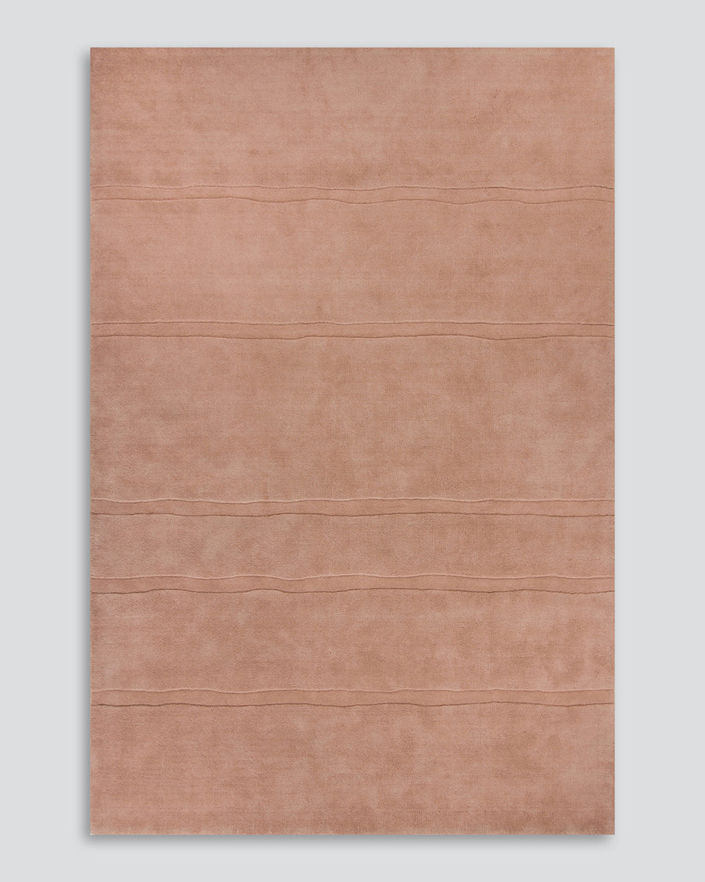 Baya Strata NZ wool floor rug in Clay, full flat view on a plain background, showing the horizontal ridged lines.