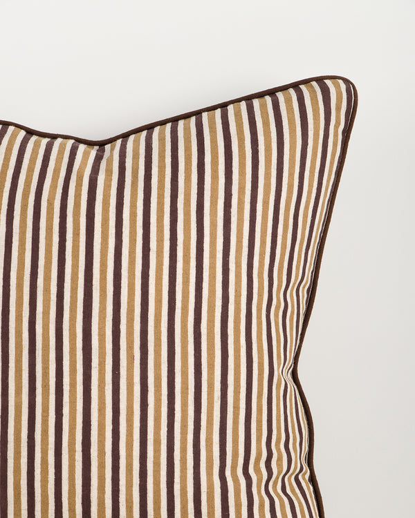 Baya Strato Cushion in Chocolate, close view of a top corner showing the stripes and dark brown piped edge.