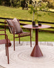 Baya Swell Outdoor Cushion in Chocolate, close styled view on an outdoor chair beside a pool.