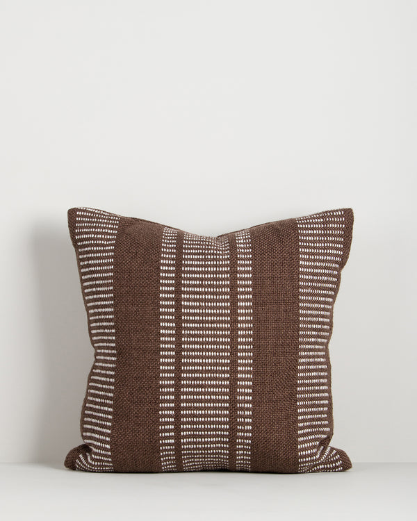 Baya Swell Outdoor Cushion in Chocolate on a plain background, showing the full double-sided stripe weave.