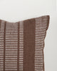 Baya Swell Outdoor Cushion in Chocolate, close view of the woven texture in off-white and chocolate-brown tones.