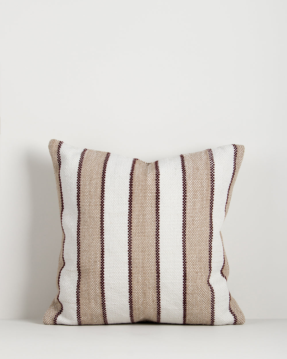 Baya Tidal Outdoor Cushion in Terracotta on a plain background, showing the camel stripe and deep red pinstripe weave.