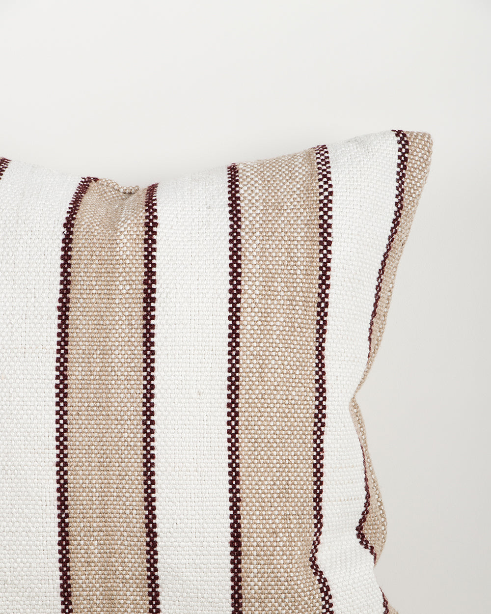 Baya Tidal Outdoor Cushion in Terracotta, close view of the woven texture in camel, ecru and deep red tones.