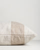 Side view of the Baya Tide Outdoor Cushion in Almond, showing the handwoven stripe wrapping the cushion edge.