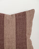 Close-up of the Baya Tide Outdoor Cushion in Claret, showing the woven linework stripe and piped edge.