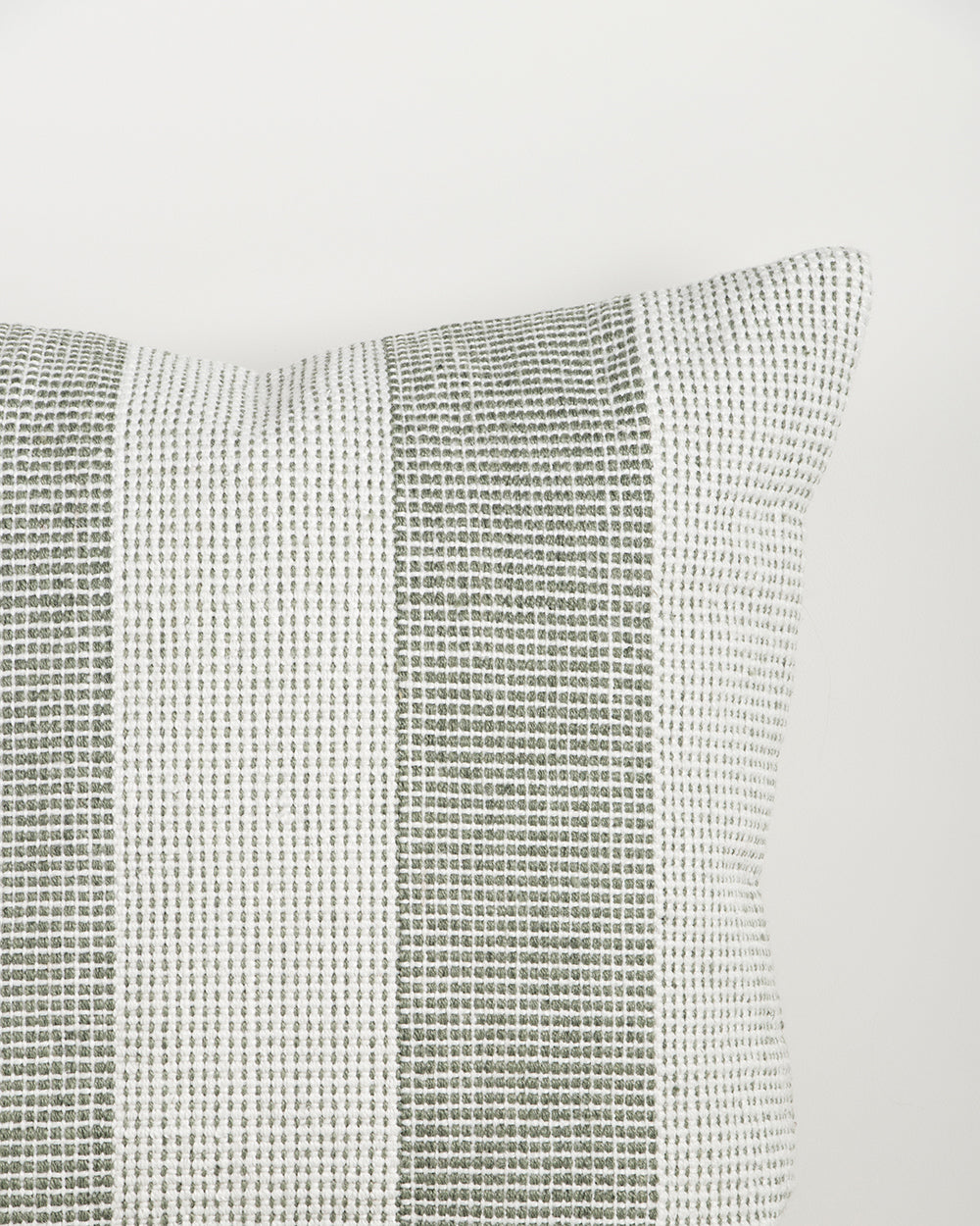 Close-up of the Baya Tide Outdoor Cushion in Eucalyptus, showing the woven linework stripe and piped edge.