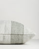 Side view of the Baya Tide Outdoor Cushion in Eucalyptus, showing the handwoven stripe wrapping the cushion edge.