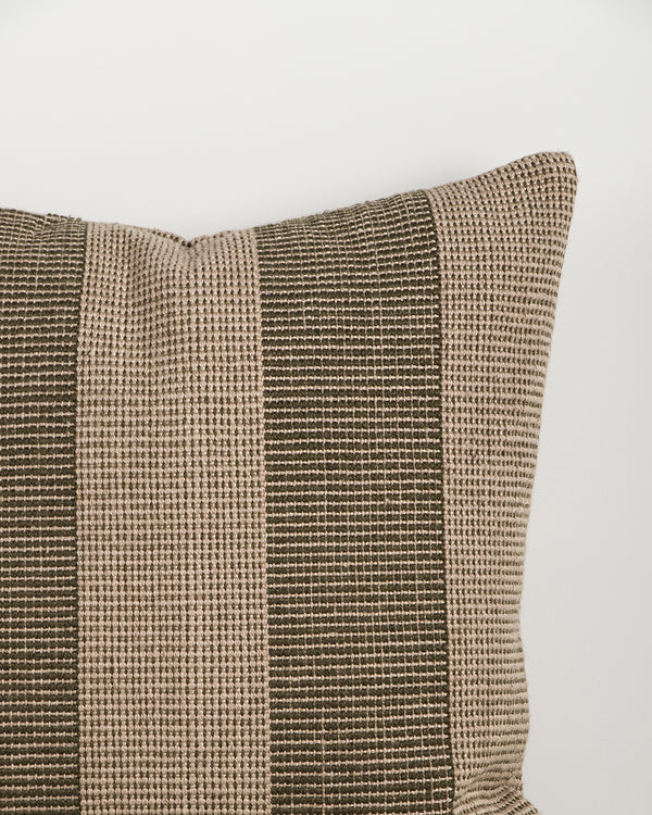 Close-up of the Baya Tide Outdoor Cushion in Mangrove, showing the woven linework stripe and piped edge.