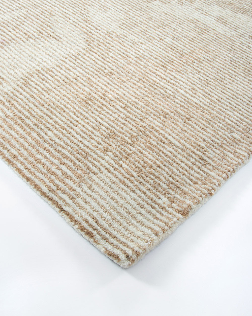 A corner image of the Beckett floor rug, showing off the textural weave of the rug. Made with 100% New Zealand wool by Baya