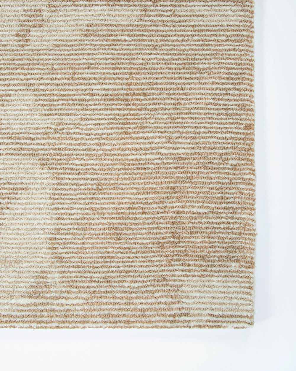 A corner image from above of the Beckett floor rug, showing off the textural weave of the rug. Made with 100% New Zealand wool by Baya