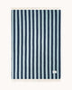 A full image of the backside of a throw blanket, spread to see the full pattern of dark blue and ice blue stripes.