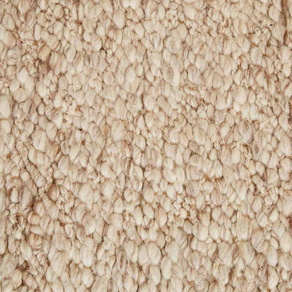 Close up of the weave of a textural wool blend boucle style rug by Globe West and Soren Liv NZ in shades of warm beige and light brown.