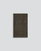 A full image of a textural dark toned entrance mat, handmade with natural jute fibres by Baya